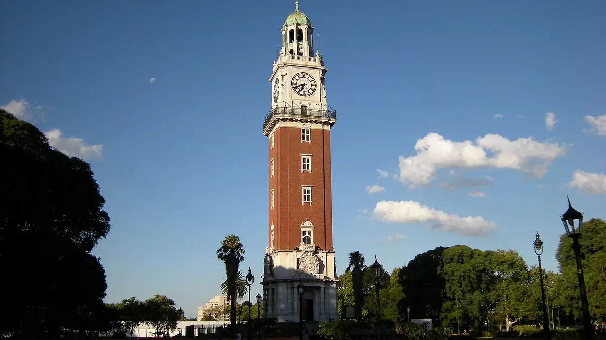 Torre Monumental de Retiro, de ladrillo rojo con reloj, contra un cielo azul con nubes
